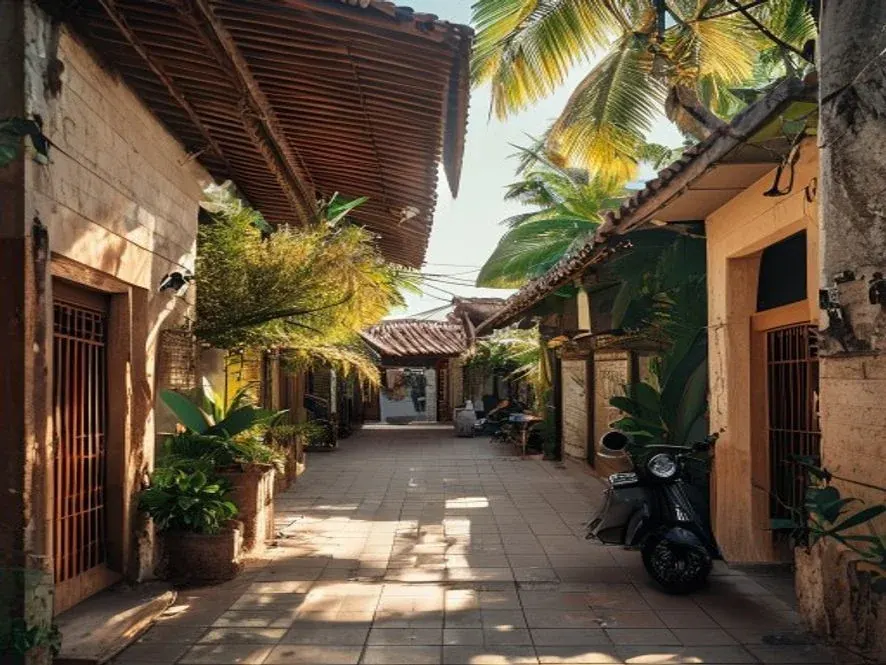 Quiet Seminyak boutique street in late afternoon with terracotta tiled roofs and tropical plants