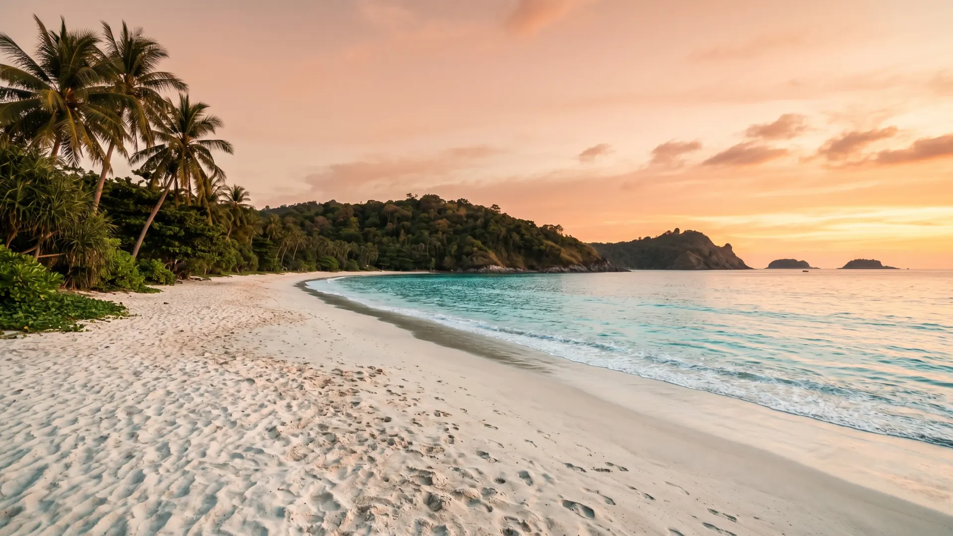 Editorial photograph of Nai Harn Beach Phuket at sunset with a secluded bay, palm trees, and Andaman Sea horizon, the mid-tier southwest corridor where a nai harn phuket villa offers capital upside