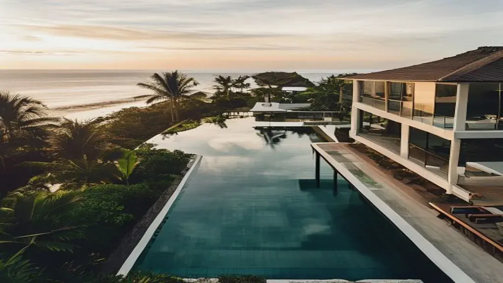 Overhead view of a Nusa Dua villa compound with infinity pool at golden hour, illustrating nusa dua property prices roi 2026