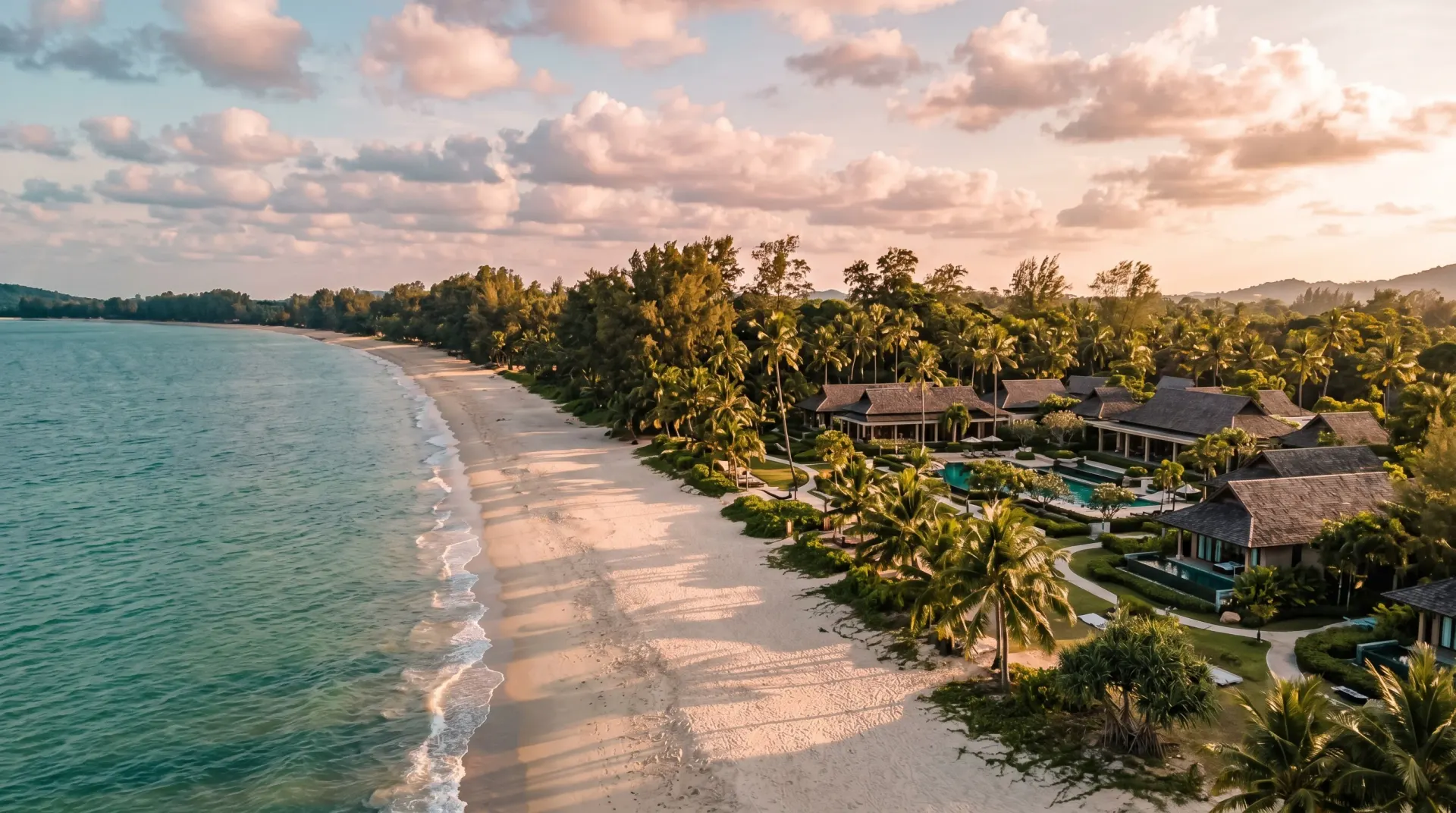 Aerial editorial photograph of Bang Tao beach Phuket at golden hour with the Laguna resort complex in the foreground