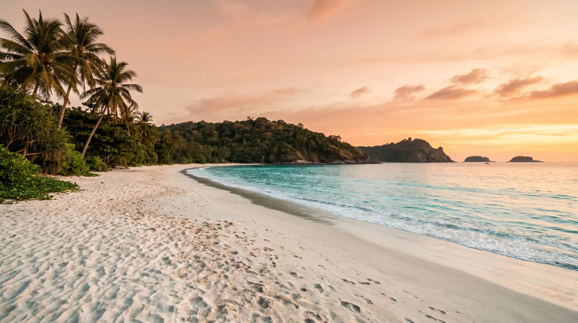 Editorial photograph of Nai Harn Beach Phuket at sunset with secluded bay, palm trees, and Andaman Sea horizon
